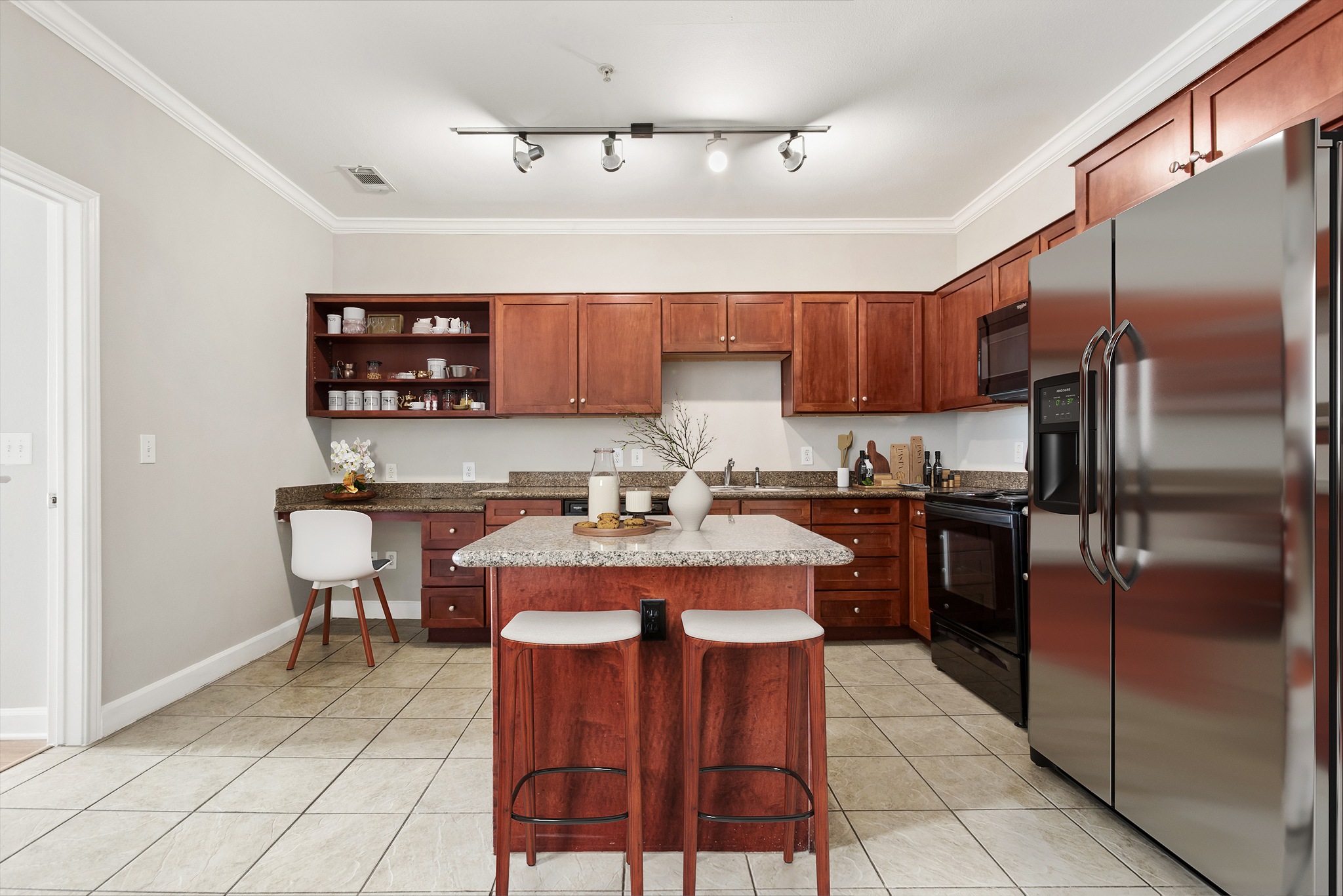 A kitchen with a white countertop and stainless steel appliances.
